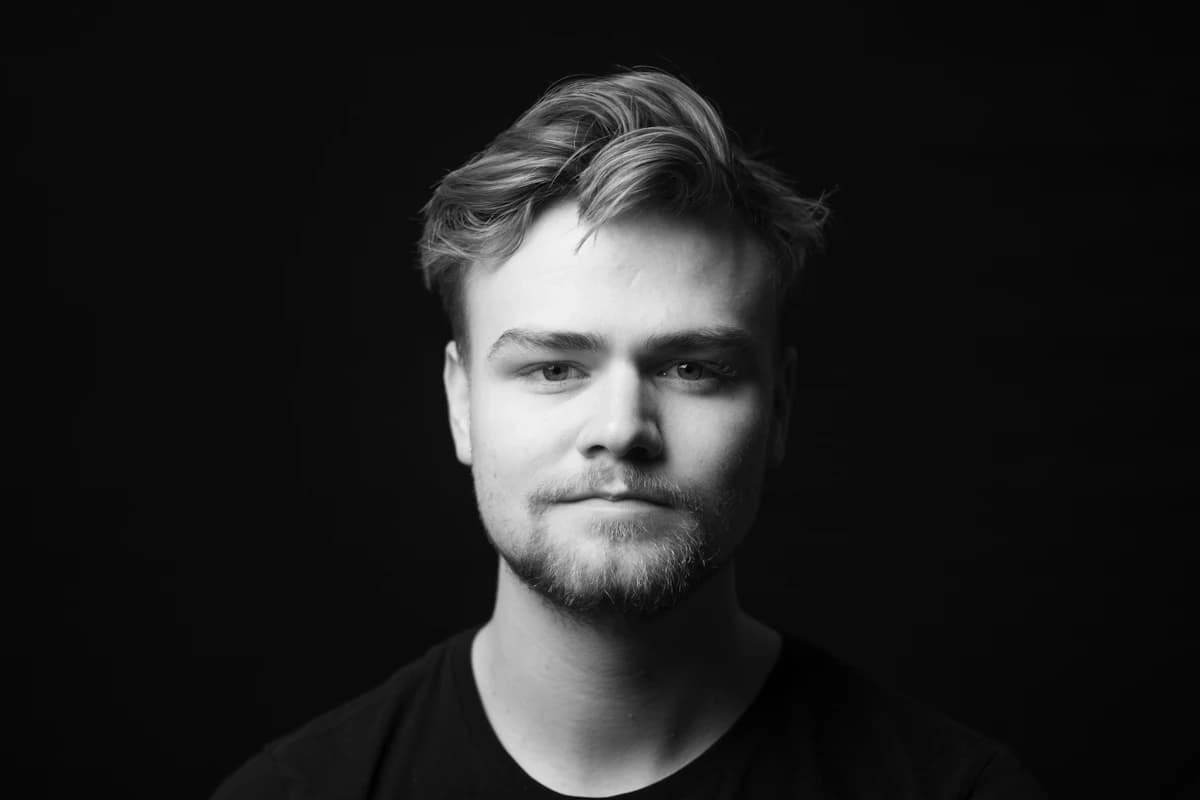 Front-facing portrait with visible hairline and neutral expression — the photo setup needed to measure facial thirds and fifths accurately